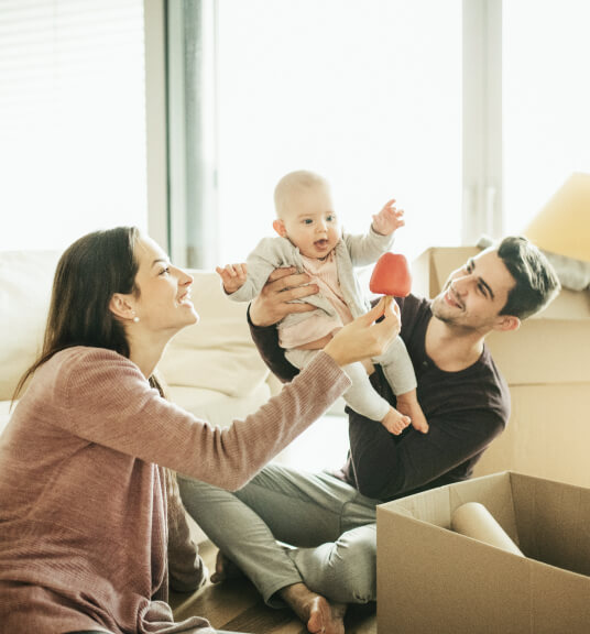 a young couple with a new baby moving